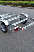 "4x8 folding aluminum utility trailer with built-in casters"

"Space-saving lightweight trailer for small vehicle hauling"

"Compact aluminum trailer folded vertically for storage"