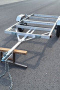 "4x8 folding aluminum utility trailer with built-in casters"

"Space-saving lightweight trailer for small vehicle hauling"

"Compact aluminum trailer folded vertically for storage"