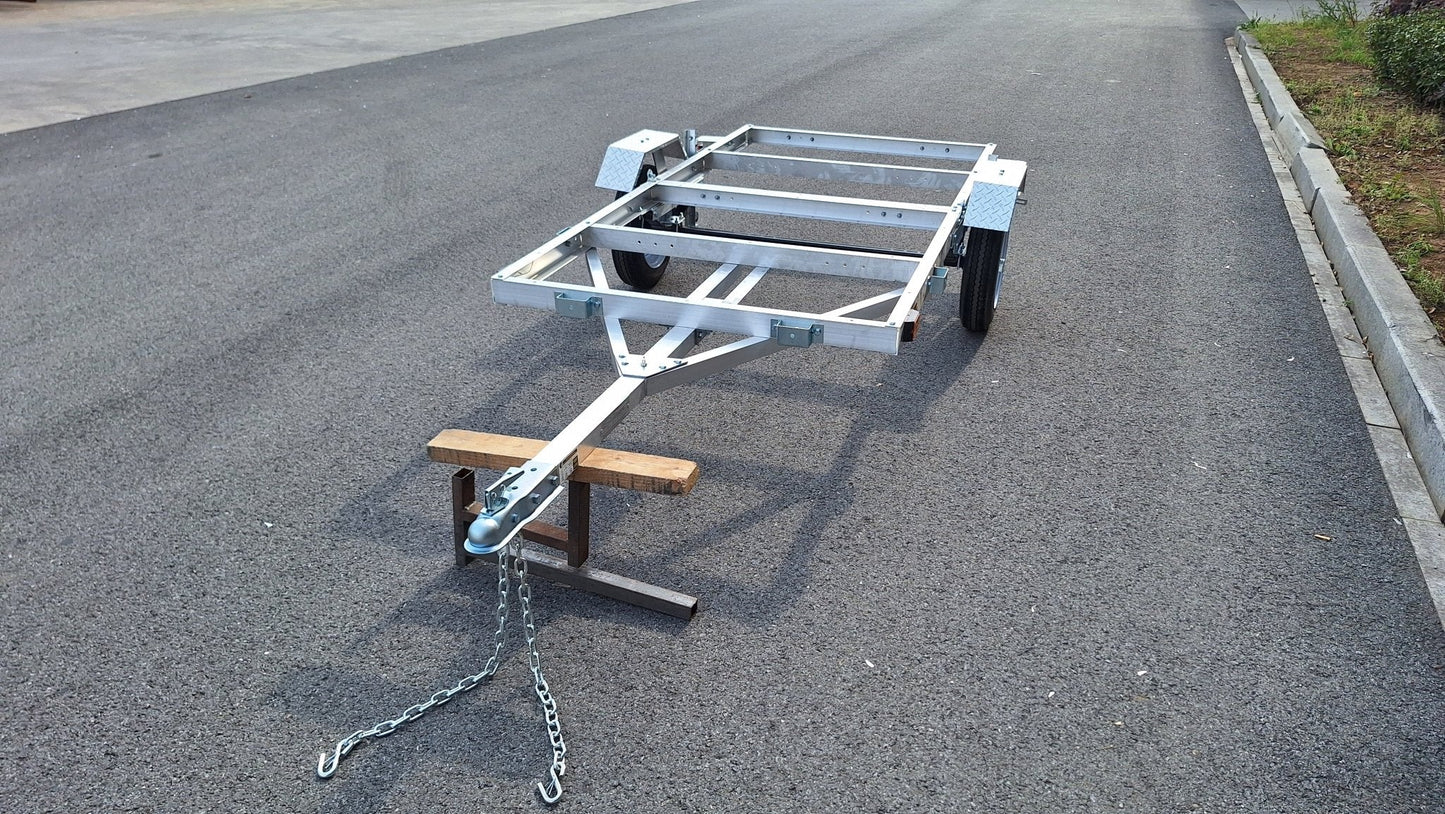 "4x8 folding aluminum utility trailer with built-in casters"

"Space-saving lightweight trailer for small vehicle hauling"

"Compact aluminum trailer folded vertically for storage"