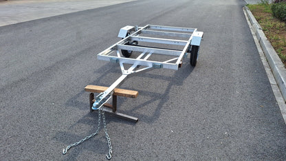 "4x8 folding aluminum utility trailer with built-in casters"

"Space-saving lightweight trailer for small vehicle hauling"

"Compact aluminum trailer folded vertically for storage"