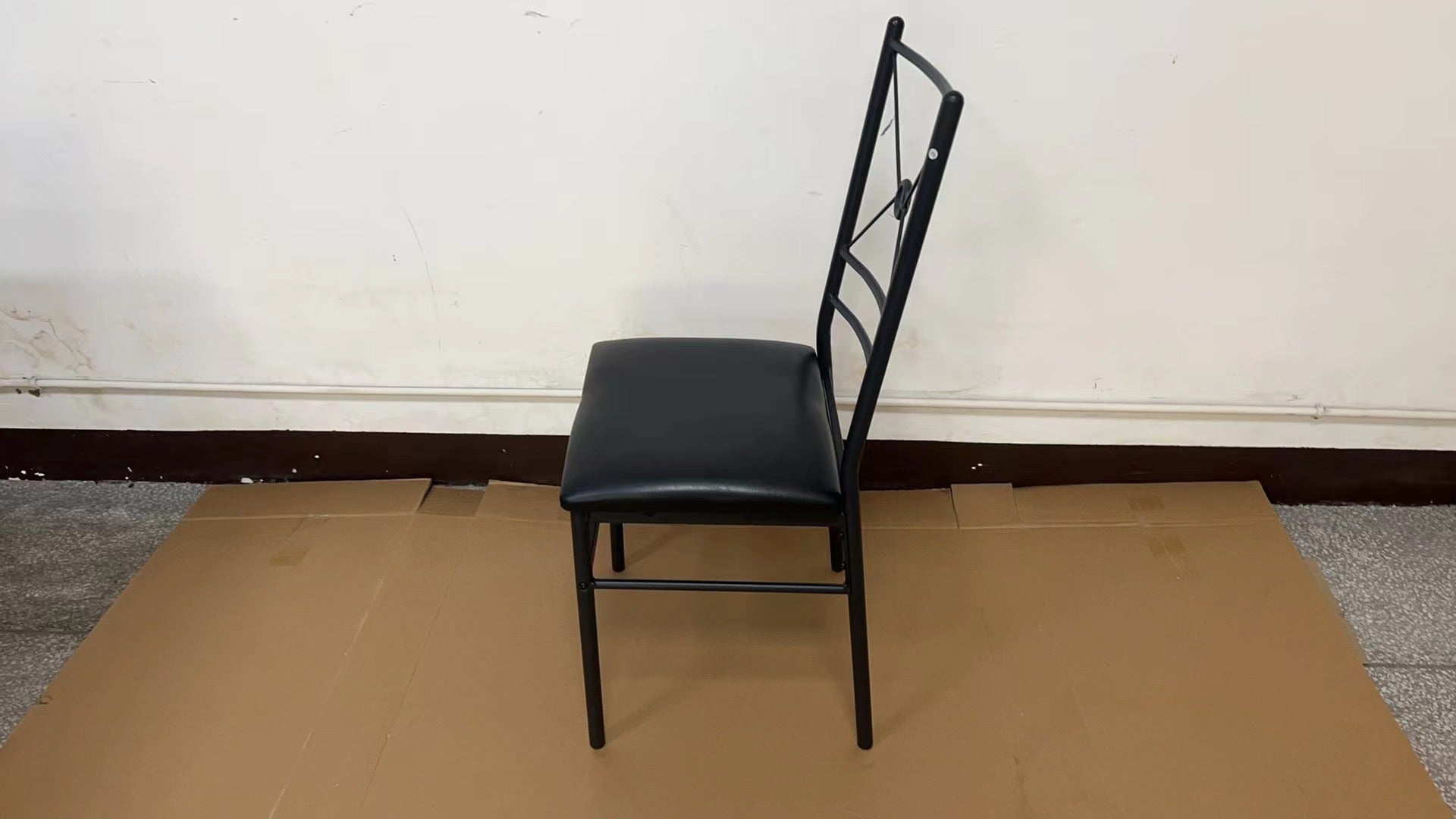“Black metal dining table set with 4 chairs in modern kitchen”

“Compact 5-piece dining set with faux leather seats”

“Close-up of black chair with slatted back and cushioned seat”

“Space-saving dining table with wood grain finish”

“Modern 5-piece table and chair set for apartments”