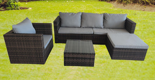 "5-piece L-shaped outdoor sectional with cushions and table"

"Modular patio furniture set in backyard setting"

"Gray cushioned patio sofa with glass coffee table"

"Weatherproof outdoor wicker sectional for patio"

"Durable resin wicker outdoor furniture with ottomans"