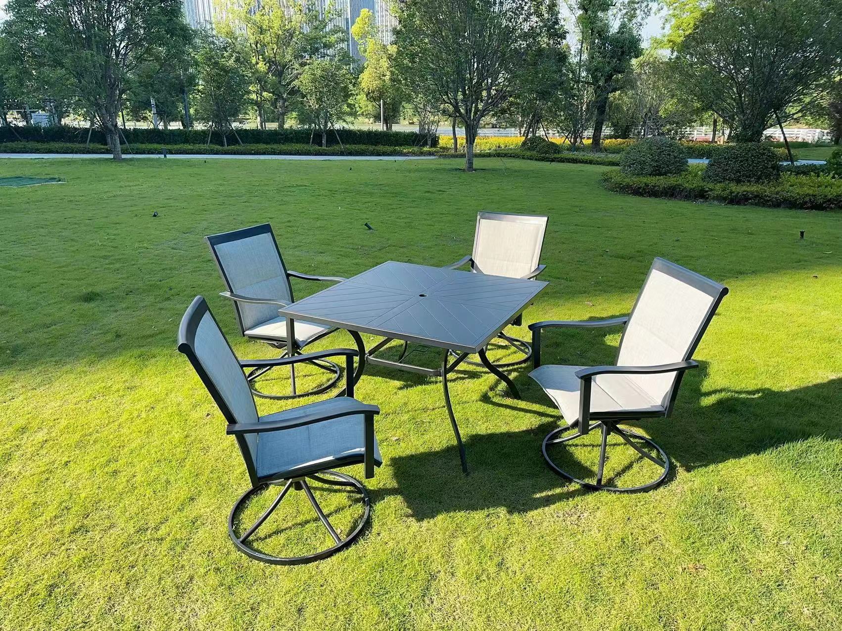 5-piece outdoor swivel dining set in garden setup

Black swivel dining chairs with cushions

Round glass-top patio dining table

Outdoor dining set with umbrella

Side view of black patio chairs and table