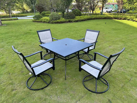 5-piece outdoor swivel dining set in garden setup

Black swivel dining chairs with cushions

Round glass-top patio dining table

Outdoor dining set with umbrella

Side view of black patio chairs and table