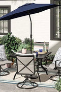 5-piece outdoor swivel dining set in garden setup

Black swivel dining chairs with cushions

Round glass-top patio dining table

Outdoor dining set with umbrella

Side view of black patio chairs and table