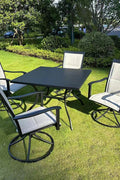 5-piece outdoor swivel dining set in garden setup

Black swivel dining chairs with cushions

Round glass-top patio dining table

Outdoor dining set with umbrella

Side view of black patio chairs and table