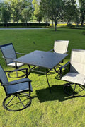 5-piece outdoor swivel dining set in garden setup

Black swivel dining chairs with cushions

Round glass-top patio dining table

Outdoor dining set with umbrella

Side view of black patio chairs and table