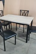 5-piece black dining table and chair set
Faux leather upholstered dining chairs
Full view of dining table with 4 chairs
Close-up of chair cushion
Dining room furniture set in black finish