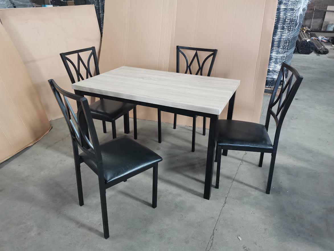 5-piece black dining table and chair set
Faux leather upholstered dining chairs
Full view of dining table with 4 chairs
Close-up of chair cushion
Dining room furniture set in black finish