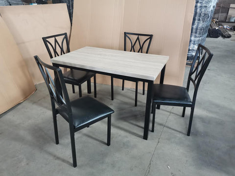 5-piece black dining table and chair set
Faux leather upholstered dining chairs
Full view of dining table with 4 chairs
Close-up of chair cushion
Dining room furniture set in black finish