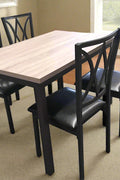 5-piece black dining table and chair set
Faux leather upholstered dining chairs
Full view of dining table with 4 chairs
Close-up of chair cushion
Dining room furniture set in black finish