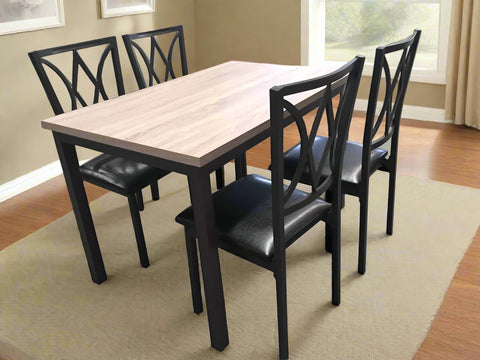 5-piece black dining table and chair set
Faux leather upholstered dining chairs
Full view of dining table with 4 chairs
Close-up of chair cushion
Dining room furniture set in black finish