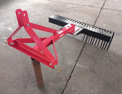 Red 5 FT landscape rake for tractor with 3-point hitch

Side view of landscape rake attachment on concrete

Close-up of tine design and mounting frame

3-point hitch mount landscape rake back view