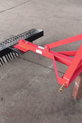 Red 5 FT landscape rake for tractor with 3-point hitch

Side view of landscape rake attachment on concrete

Close-up of tine design and mounting frame

3-point hitch mount landscape rake back view