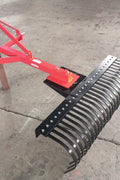 Red 5 FT landscape rake for tractor with 3-point hitch

Side view of landscape rake attachment on concrete

Close-up of tine design and mounting frame

3-point hitch mount landscape rake back view