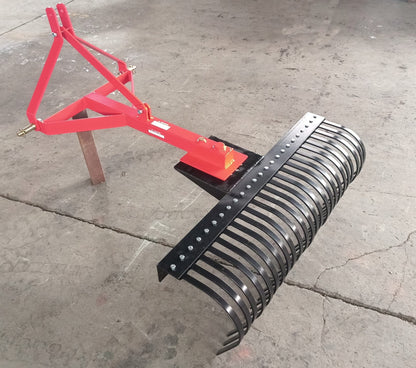 Red 5 FT landscape rake for tractor with 3-point hitch

Side view of landscape rake attachment on concrete

Close-up of tine design and mounting frame

3-point hitch mount landscape rake back view