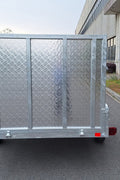 "5x8 galvanized utility trailer with built-in ATV ramps"

"Rust-resistant utility trailer parked near grass lot"

"Heavy-duty galvanized trailer with side view of ramps"