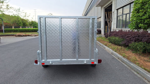 "5x8 galvanized utility trailer with built-in ATV ramps"

"Rust-resistant utility trailer parked near grass lot"

"Heavy-duty galvanized trailer with side view of ramps"