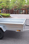"5x8 galvanized utility trailer with built-in ATV ramps"

"Rust-resistant utility trailer parked near grass lot"

"Heavy-duty galvanized trailer with side view of ramps"