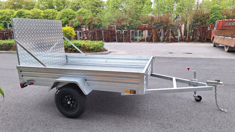 "5x8 galvanized utility trailer with built-in ATV ramps"

"Rust-resistant utility trailer parked near grass lot"

"Heavy-duty galvanized trailer with side view of ramps"