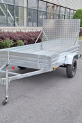"5x8 galvanized utility trailer with built-in ATV ramps"

"Rust-resistant utility trailer parked near grass lot"

"Heavy-duty galvanized trailer with side view of ramps"