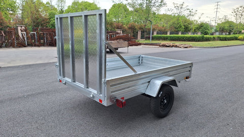 "5x8 galvanized utility trailer with built-in ATV ramps"

"Rust-resistant utility trailer parked near grass lot"

"Heavy-duty galvanized trailer with side view of ramps"
