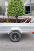 "5x8 galvanized utility trailer with built-in ATV ramps"

"Rust-resistant utility trailer parked near grass lot"

"Heavy-duty galvanized trailer with side view of ramps"