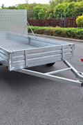 "5x8 galvanized utility trailer with built-in ATV ramps"

"Rust-resistant utility trailer parked near grass lot"

"Heavy-duty galvanized trailer with side view of ramps"