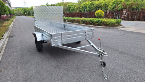 "5x8 galvanized utility trailer with built-in ATV ramps"

"Rust-resistant utility trailer parked near grass lot"

"Heavy-duty galvanized trailer with side view of ramps"