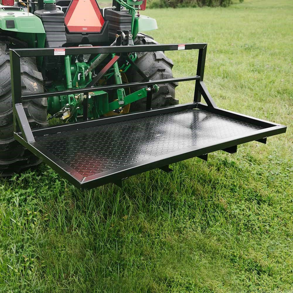 6 FT carry all platform for tractors – 3-point hitch rear attachment
Rear view of black steel tractor carry platform with diamond plate deck
Close-up of pallet fork-compatible blade pockets on tractor platform