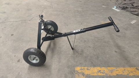 Manual hitch dolly TD600 with trailer hookup on pavement

Close-up of TD600 trailer dolly wheels and hitch ball

Side view of trailer dolly being manually pushed

Hand-push trailer dolly on gravel driveway