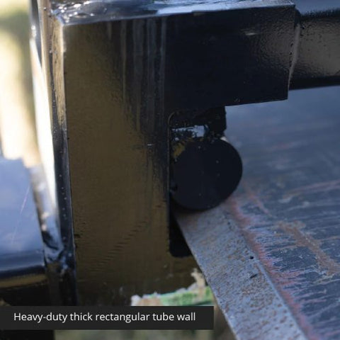 Heavy-duty clamp-on pallet forks attached to tractor bucket
Side view of 60-inch pallet forks with stabilizer bar
Close-up of fork clamps and locking bolts
Rear view showing rollback guard on pallet fork
Forks lifting lumber/crates on farm terrain