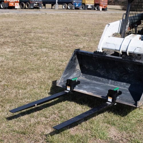 Heavy-duty clamp-on pallet forks attached to tractor bucket
Side view of 60-inch pallet forks with stabilizer bar
Close-up of fork clamps and locking bolts
Rear view showing rollback guard on pallet fork
Forks lifting lumber/crates on farm terrain