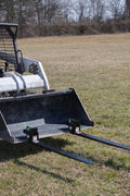 Heavy-duty clamp-on pallet forks attached to tractor bucket
Side view of 60-inch pallet forks with stabilizer bar
Close-up of fork clamps and locking bolts
Rear view showing rollback guard on pallet fork
Forks lifting lumber/crates on farm terrain