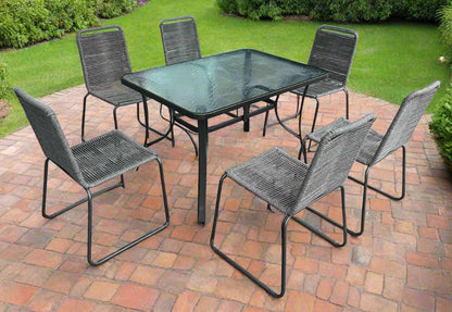 Full 7-piece patio dining set with 6 chairs and steel table

Close-up of stackable outdoor chair with armrest

Outdoor dining table surface with modern weather-resistant finish

Chairs stacked for space-saving storage

Patio dining set placed in backyard setting
