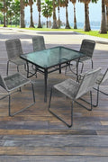 Full 7-piece patio dining set with 6 chairs and steel table

Close-up of stackable outdoor chair with armrest

Outdoor dining table surface with modern weather-resistant finish

Chairs stacked for space-saving storage

Patio dining set placed in backyard setting