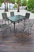 Full 7-piece patio dining set with 6 chairs and steel table

Close-up of stackable outdoor chair with armrest

Outdoor dining table surface with modern weather-resistant finish

Chairs stacked for space-saving storage

Patio dining set placed in backyard setting