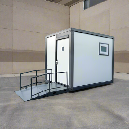 7-foot ADA-compliant portable restroom with ramp in outdoor setting
Inside view of wheelchair-accessible bathroom interior
Front door of handicap bathroom unit with ramp
Washbasin and toilet setup in ADA portable unit
Side view of accessible bathroom setup