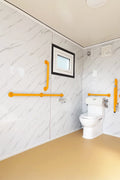 7-foot ADA-compliant portable restroom with ramp in outdoor setting
Inside view of wheelchair-accessible bathroom interior
Front door of handicap bathroom unit with ramp
Washbasin and toilet setup in ADA portable unit
Side view of accessible bathroom setup