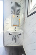 7-foot ADA-compliant portable restroom with ramp in outdoor setting
Inside view of wheelchair-accessible bathroom interior
Front door of handicap bathroom unit with ramp
Washbasin and toilet setup in ADA portable unit
Side view of accessible bathroom setup