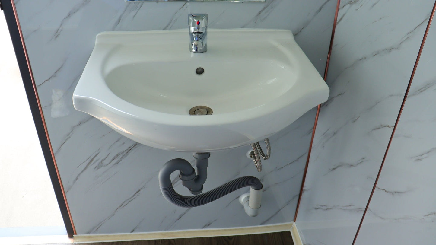 7-foot ADA-compliant portable restroom with ramp in outdoor setting
Inside view of wheelchair-accessible bathroom interior
Front door of handicap bathroom unit with ramp
Washbasin and toilet setup in ADA portable unit
Side view of accessible bathroom setup