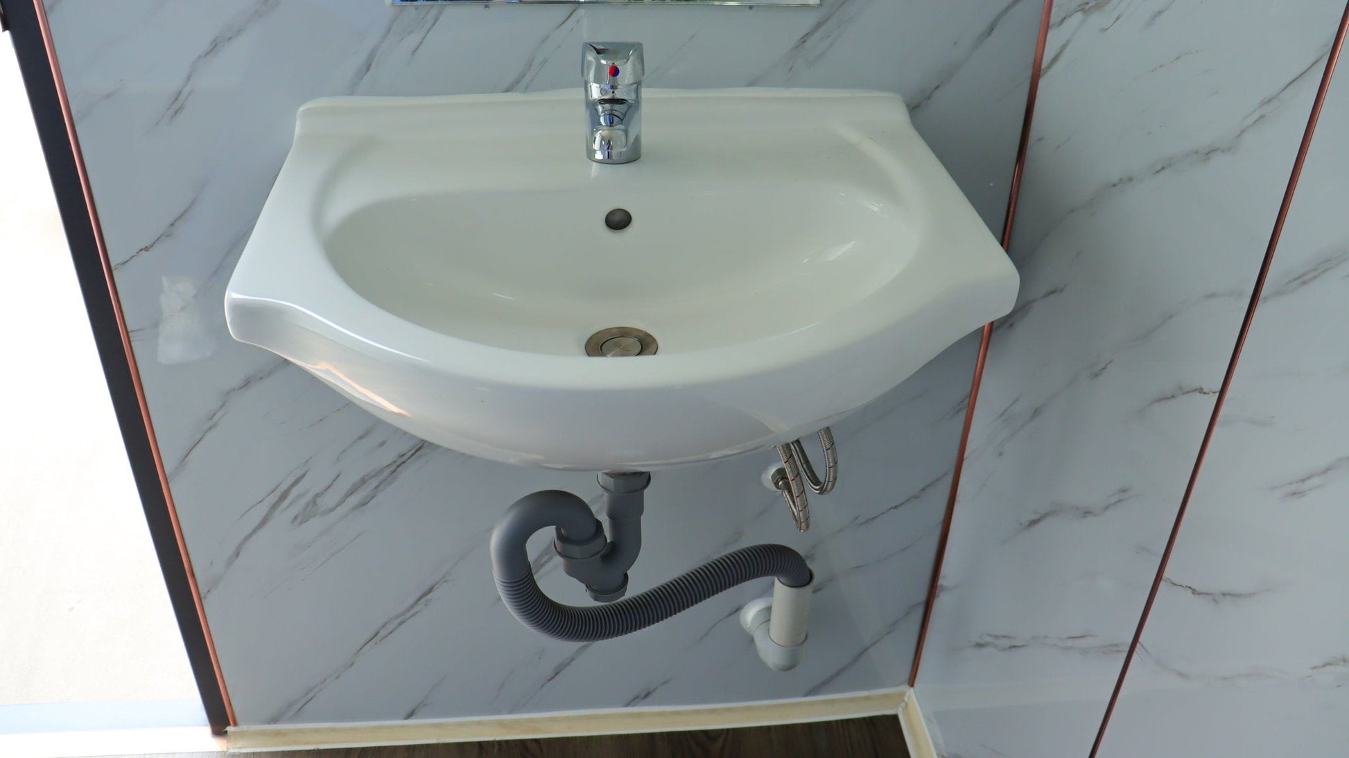 7-foot ADA-compliant portable restroom with ramp in outdoor setting
Inside view of wheelchair-accessible bathroom interior
Front door of handicap bathroom unit with ramp
Washbasin and toilet setup in ADA portable unit
Side view of accessible bathroom setup