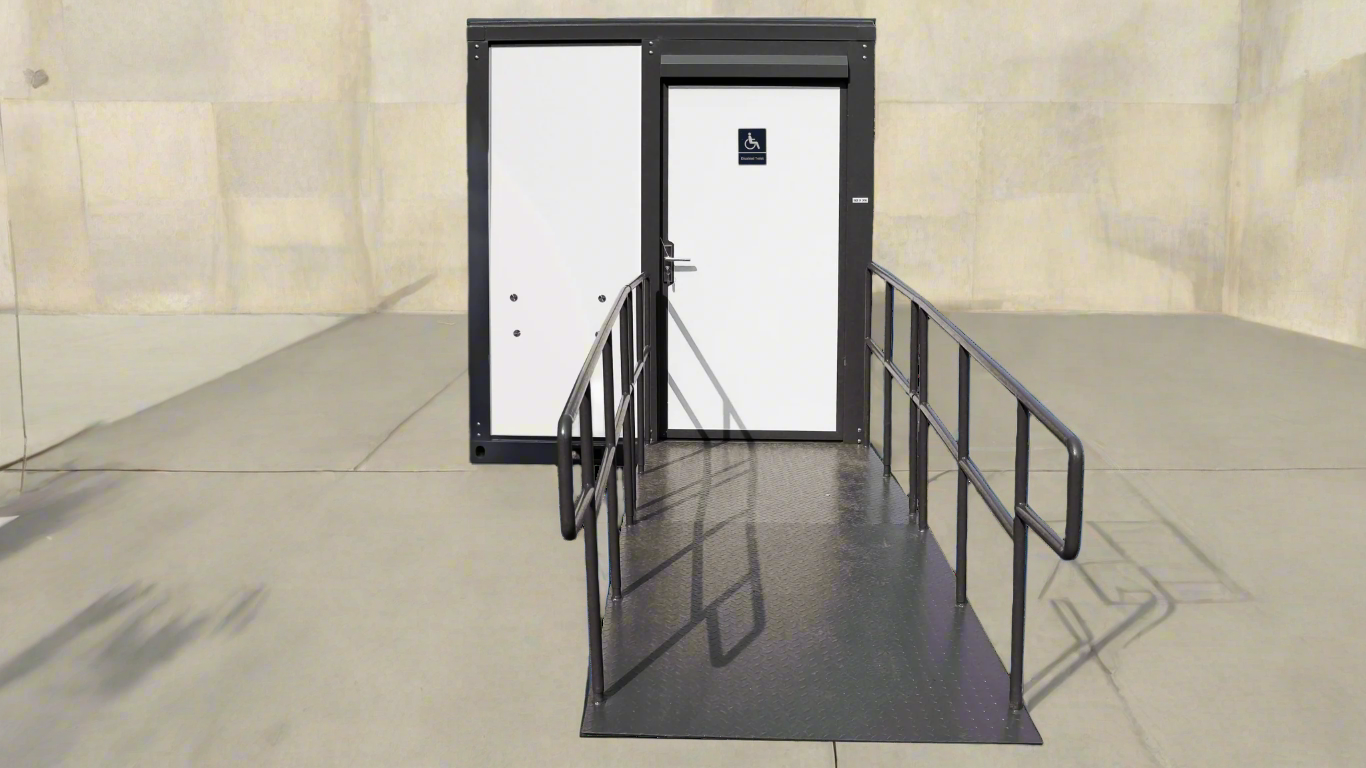 7-foot ADA-compliant portable restroom with ramp in outdoor setting
Inside view of wheelchair-accessible bathroom interior
Front door of handicap bathroom unit with ramp
Washbasin and toilet setup in ADA portable unit
Side view of accessible bathroom setup