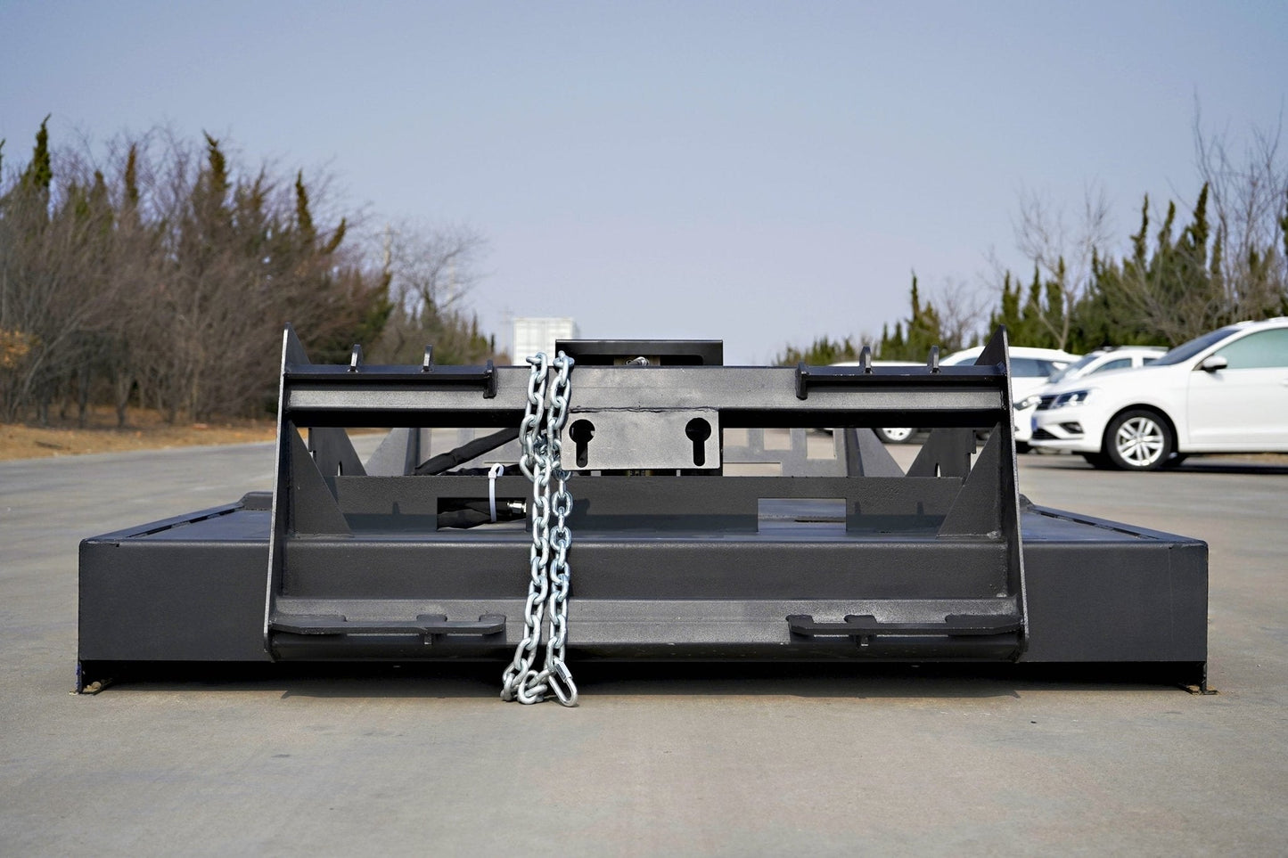 72 inch skid steer brush mower angled view

Underside of heavy-duty cutting blades

66 inch mower installed on skid steer

Skid steer clearing brush and saplings

Blade set and replacement part display