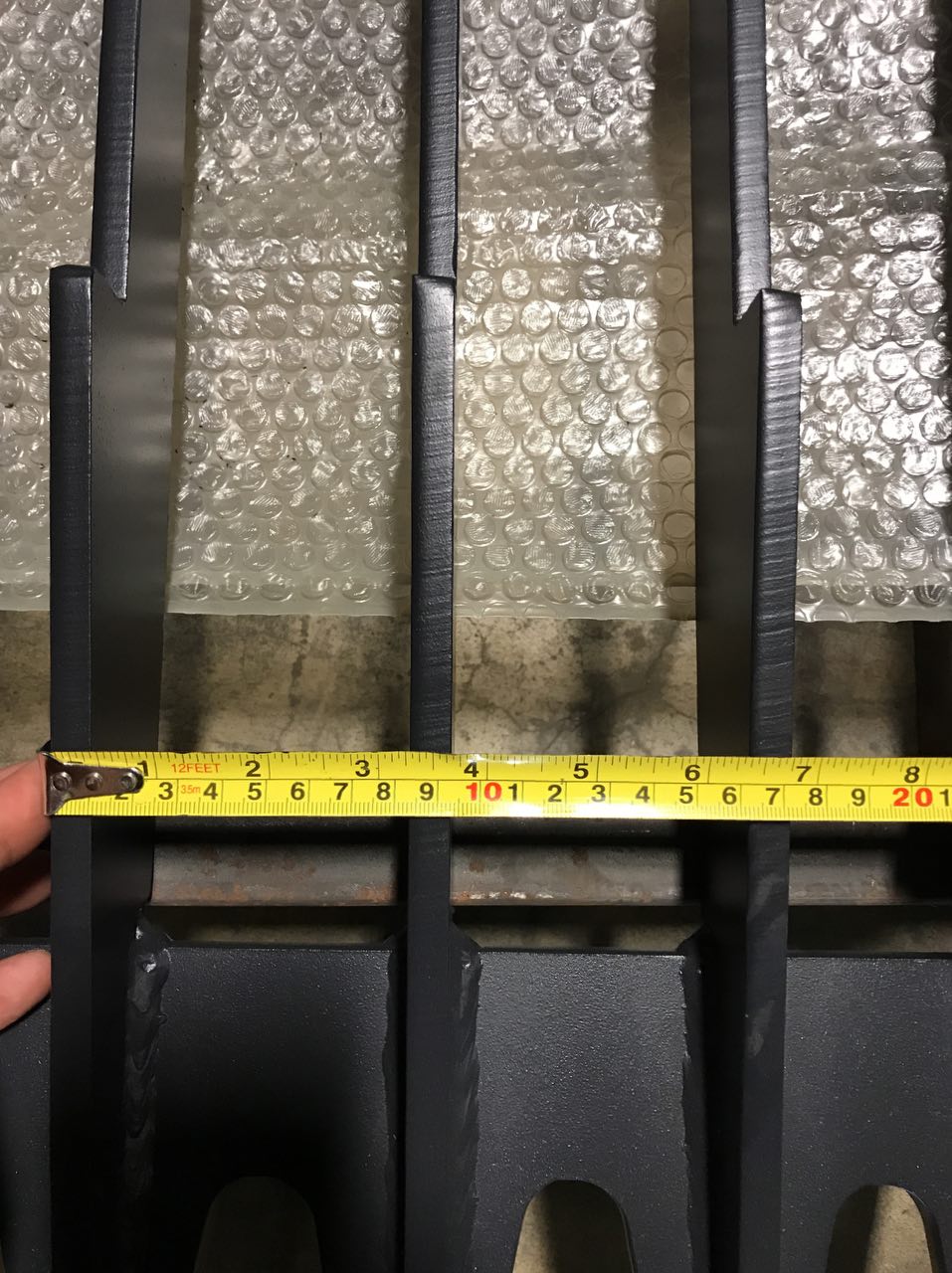 Heavy-duty skid steer skeleton rock bucket – front angled view

Close-up of reinforced steel tines and grapple mounts

84” rock bucket on skid steer in yard cleanup

Side view of skeleton-style skid loader bucket

Multiple bucket sizes displayed on gravel lot