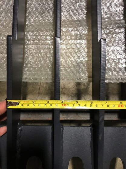 Heavy-duty skid steer skeleton rock bucket – front angled view

Close-up of reinforced steel tines and grapple mounts

84” rock bucket on skid steer in yard cleanup

Side view of skeleton-style skid loader bucket

Multiple bucket sizes displayed on gravel lot