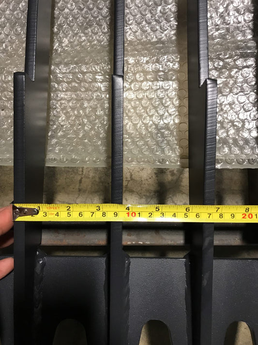 Heavy-duty skid steer skeleton rock bucket – front angled view

Close-up of reinforced steel tines and grapple mounts

84” rock bucket on skid steer in yard cleanup

Side view of skeleton-style skid loader bucket

Multiple bucket sizes displayed on gravel lot