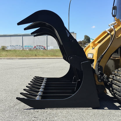 72" skid steer grapple bucket front view

84" rock grapple on skid steer in action

Close-up of dual hydraulic cylinder and hose setup

Heavy-duty tines and steel frame

Grapple holding large rocks and debris

