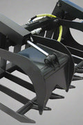 72" skid steer grapple bucket front view

84" rock grapple on skid steer in action

Close-up of dual hydraulic cylinder and hose setup

Heavy-duty tines and steel frame

Grapple holding large rocks and debris

