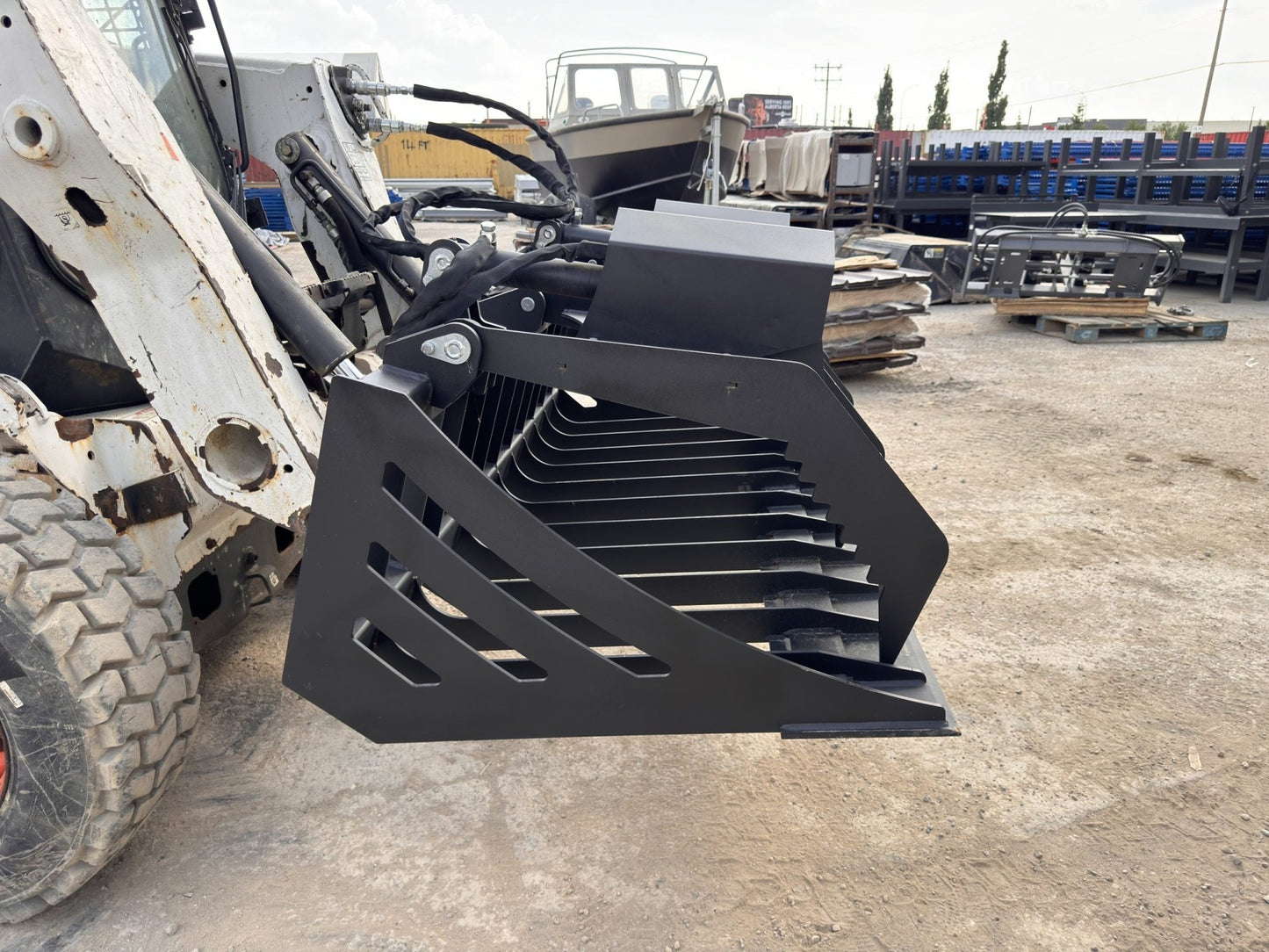 72" hydraulic grapple bucket on skid steer

Skid steer rock grapple front view

Close-up of grapple teeth and hoses

Dual-cylinder grapple open position

Grapple attachment lifting heavy debris